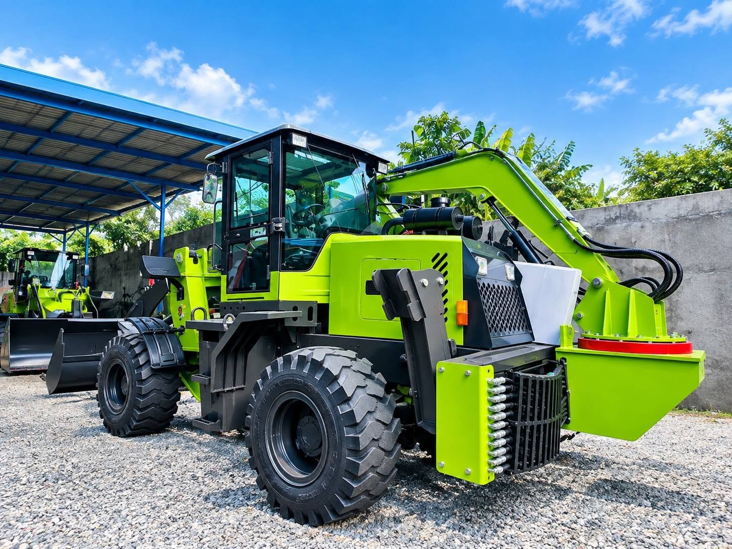 Green backhoe loader at equipment yard